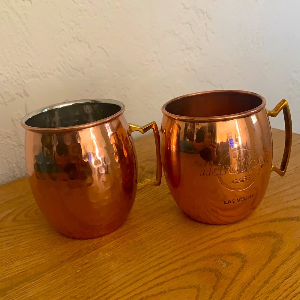 2 Moscow Mule Mugs. Hard Rock Cafe is copper and the other is stainless steel.